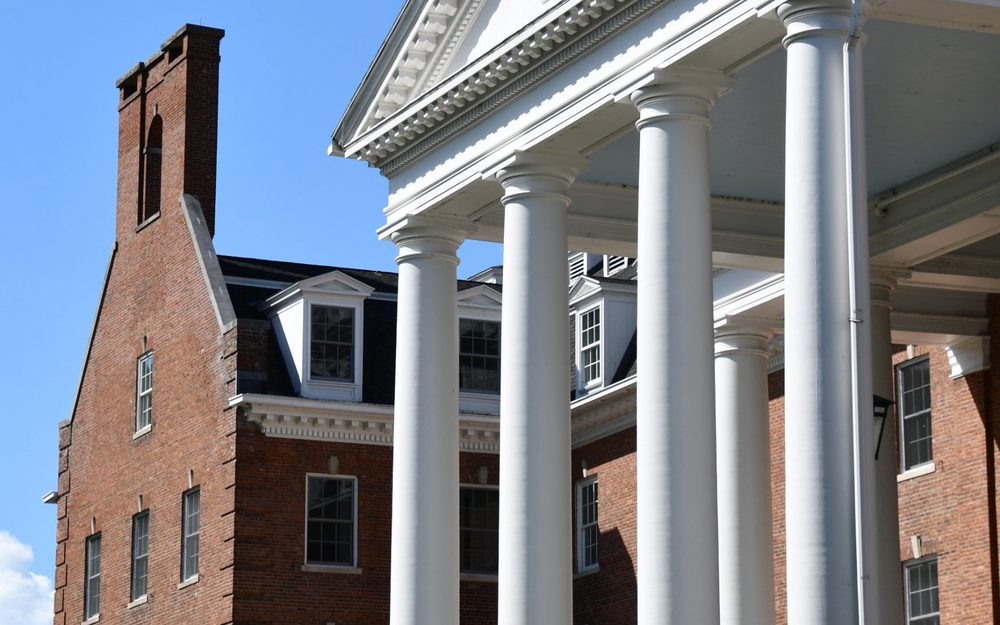 Large brick building with a white columned portico